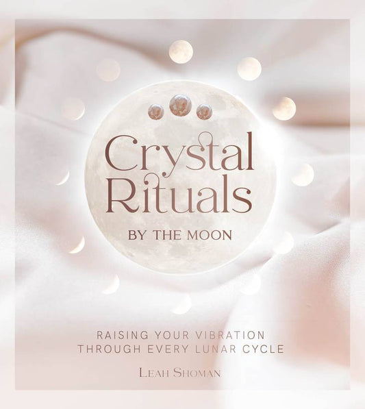 Book cover of 'Crystal Rituals by the Moon' by Leah Shoman with a moon design and soft background.