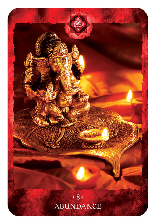 Gold statue of a deity on a red background with candles, labeled 'Abundance'.
