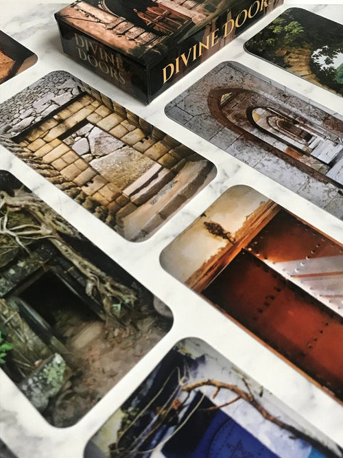 Close-up of 'Divine Doors' cards with detailed illustrations.