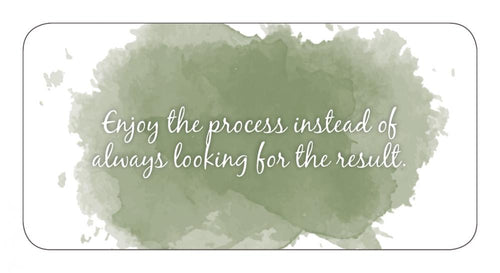Motivational quote on a watercolor background with a green splash.