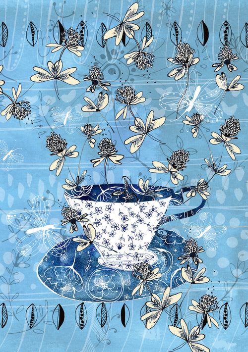 Blue teacup with floral design on a blue background