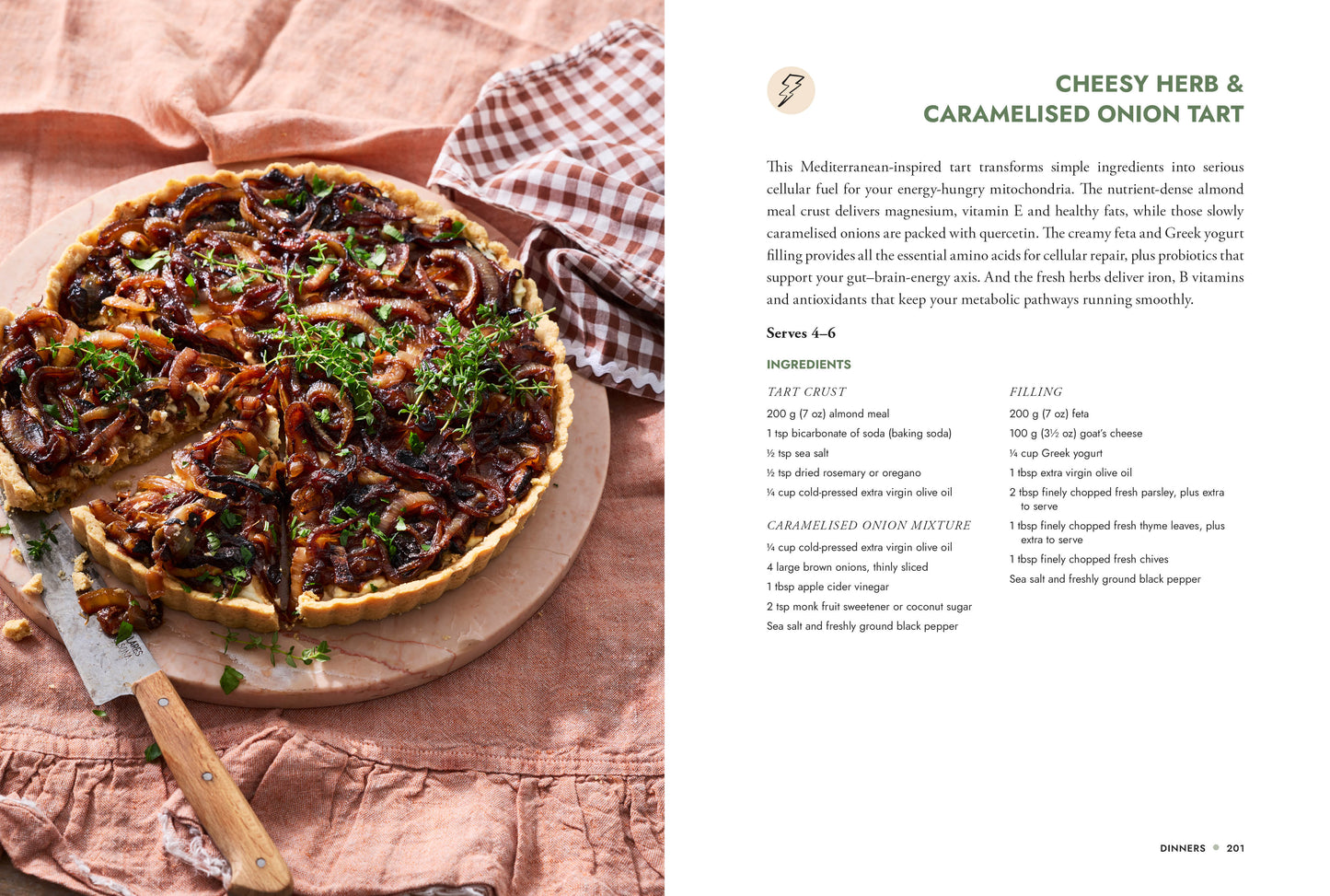 Cheesy herb and caramelised onion tart on a wooden board with a recipe card on the side.