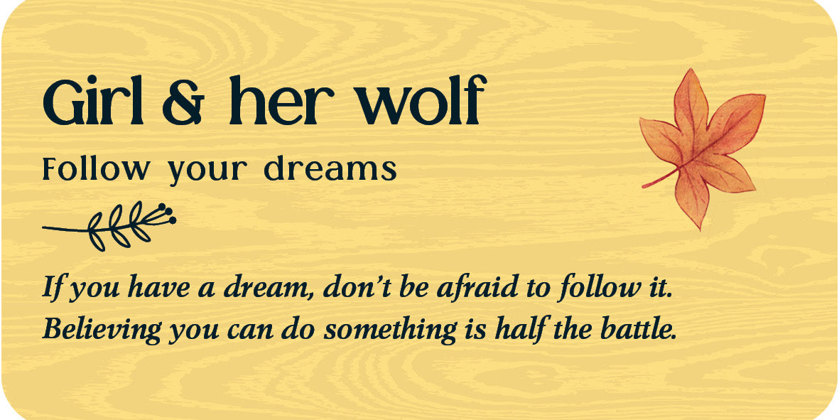 Wooden plaque with text 'Girl & her wolf Follow your dreams' and a leaf design on a wooden background.