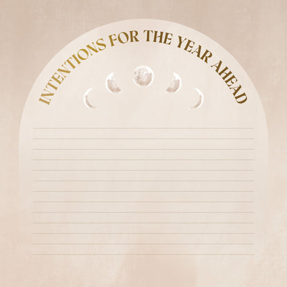 Notebook with 'Intentions for the Year Ahead' text and moon phase symbols on a beige background