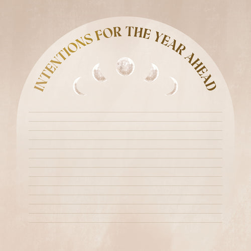 Notebook with 'Intentions for the Year Ahead' text and moon phase symbols on a beige background